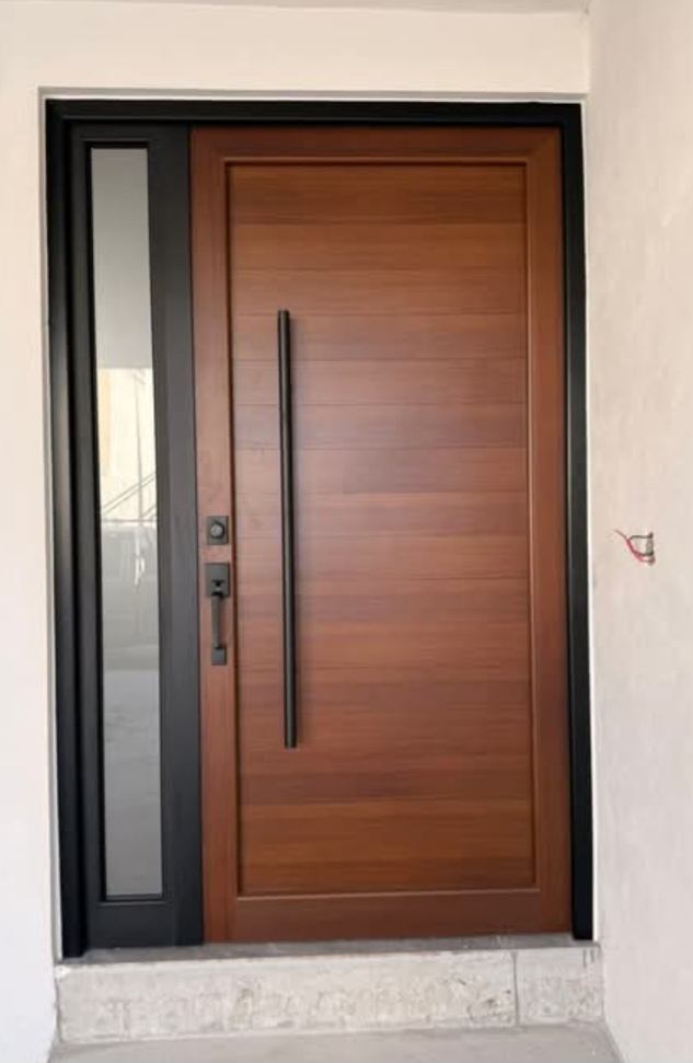 Puerta de entrada símil madera con manijón y paño lateral vidriado